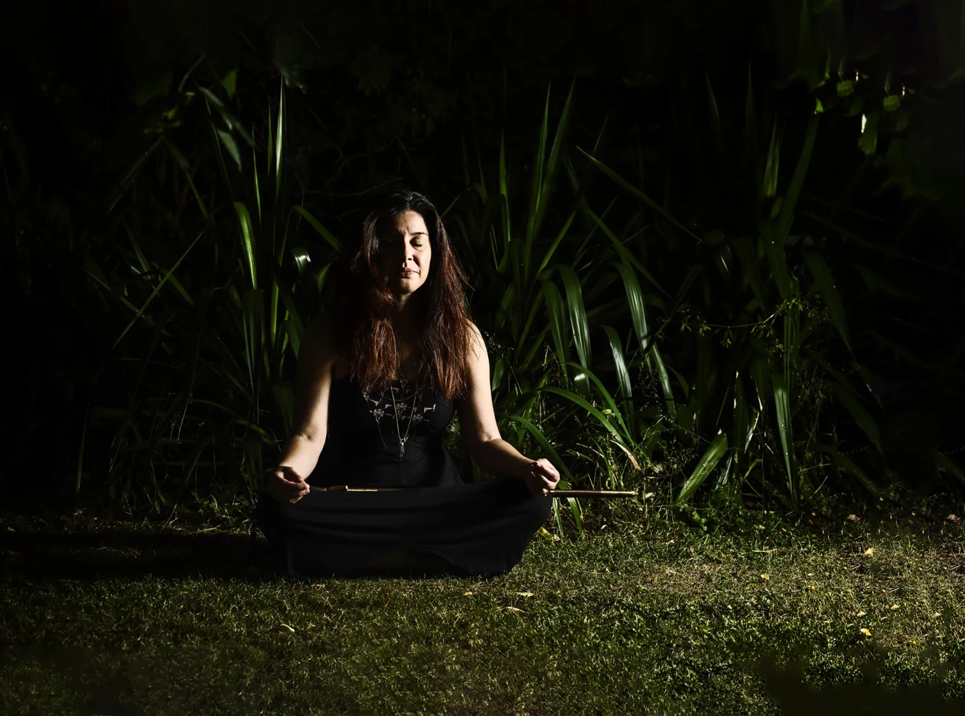 Kat Chu seated amongst greenery